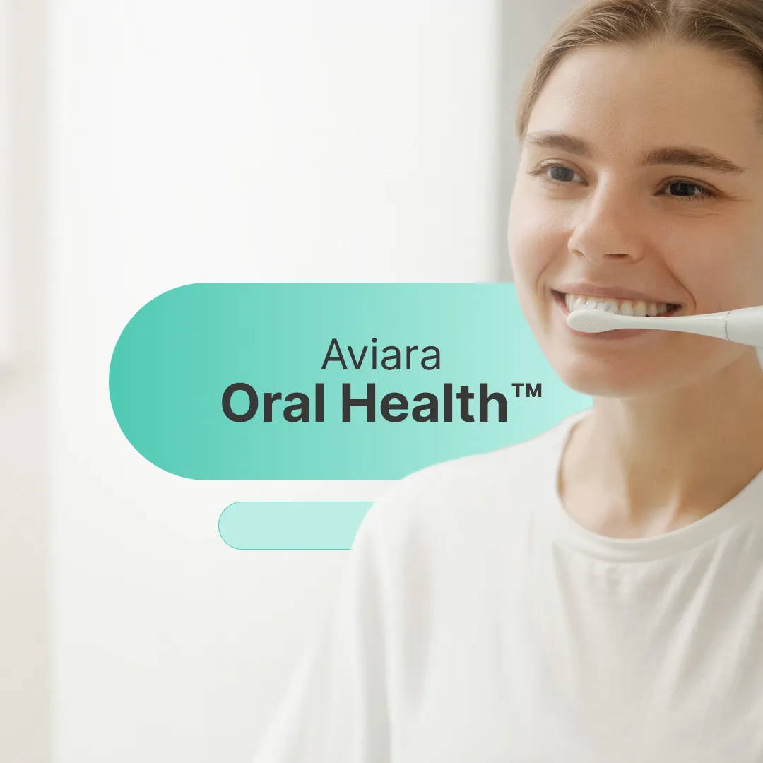 Woman brushing teeth with electric toothbrush, promoting oral health.